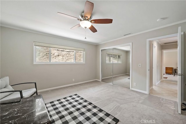 living area featuring ceiling fan, ornamental molding, and light carpet