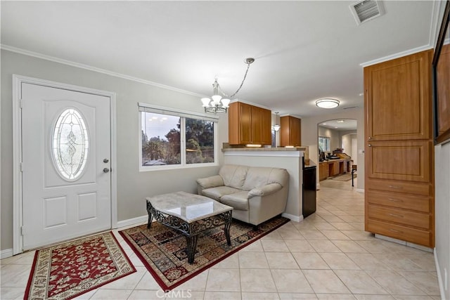 tiled foyer featuring crown molding and a notable chandelier