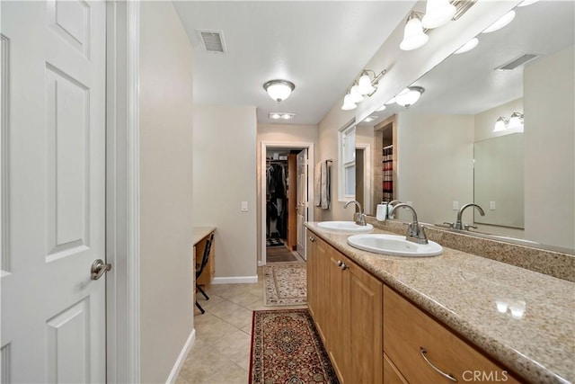 bathroom with tile patterned flooring and vanity