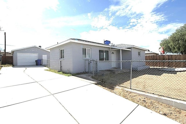 view of front of house featuring a garage and an outdoor structure