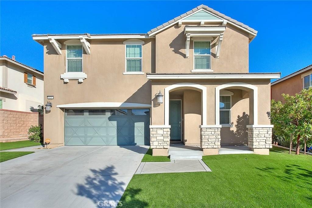 view of front of house with a garage and a front yard