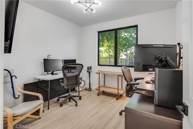 home office featuring light hardwood / wood-style flooring and a notable chandelier