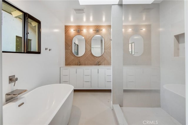 bathroom with a washtub and vanity