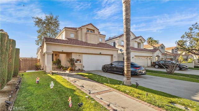 view of front of property featuring stucco siding, concrete driveway, fence, a garage, and a front lawn