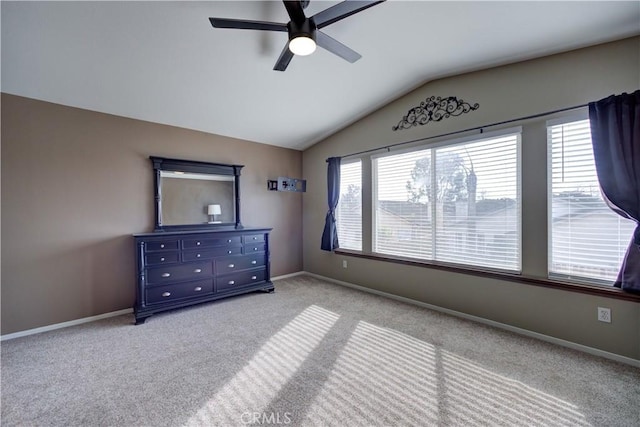 bedroom featuring ceiling fan, lofted ceiling, and light carpet