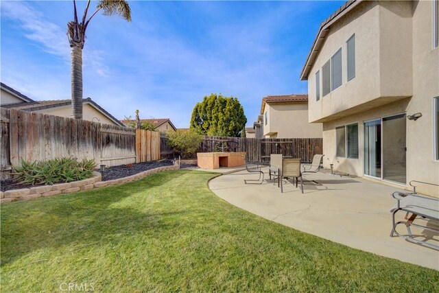 view of yard with a patio and a fenced backyard