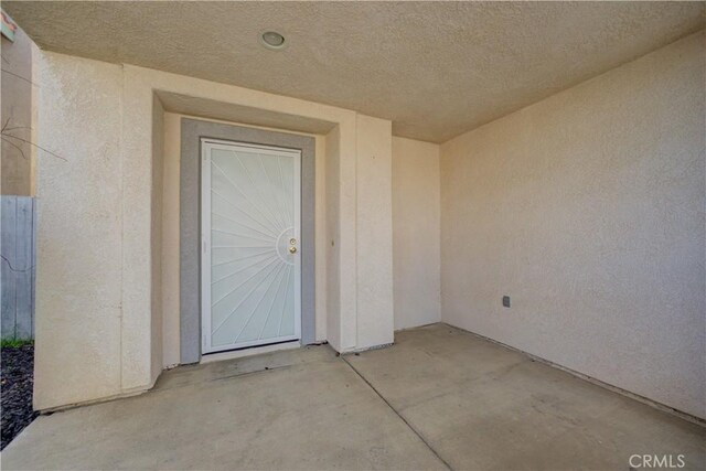 property entrance with stucco siding