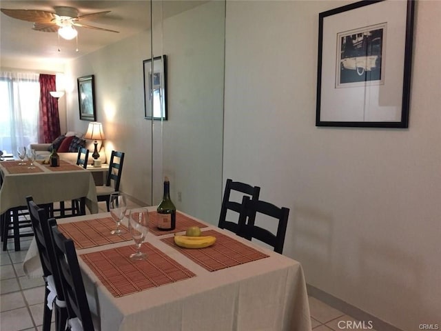 tiled dining space with ceiling fan