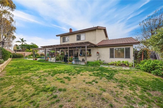 back of property with a yard, a pergola, and a patio