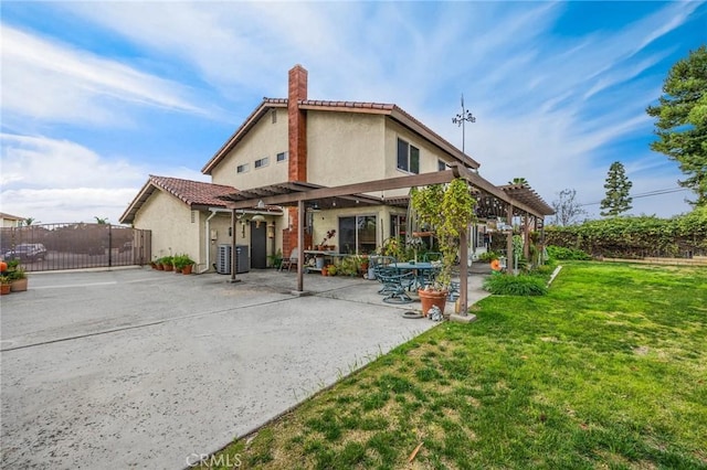 rear view of house with a patio, a lawn, cooling unit, and a pergola