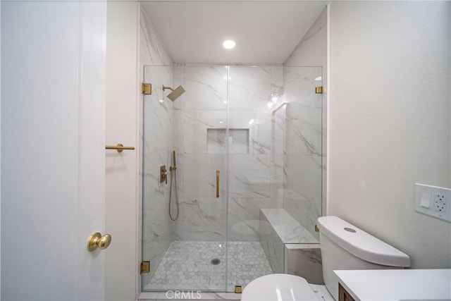 bathroom with a shower with door and toilet