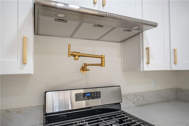 room details with white cabinetry and gas range