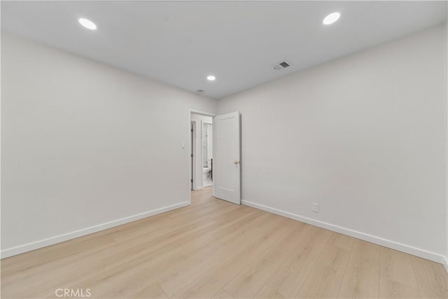 spare room with light hardwood / wood-style flooring