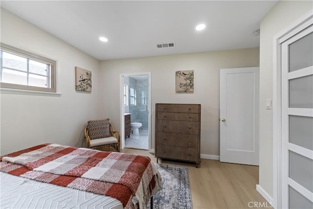 bedroom featuring light hardwood / wood-style flooring and ensuite bathroom