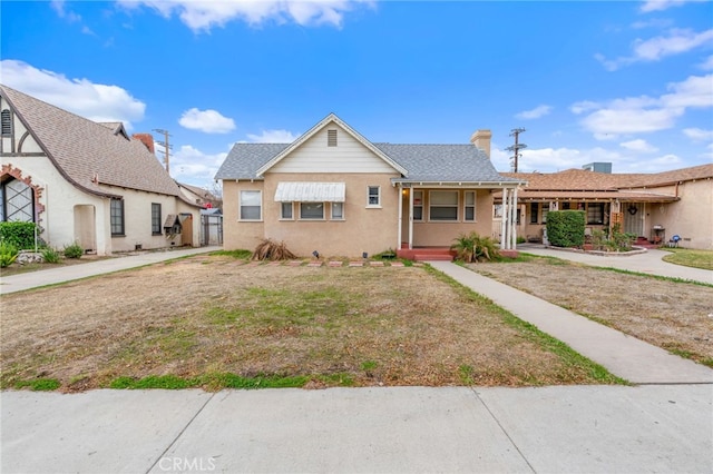 view of front of home with a porch and a front yard