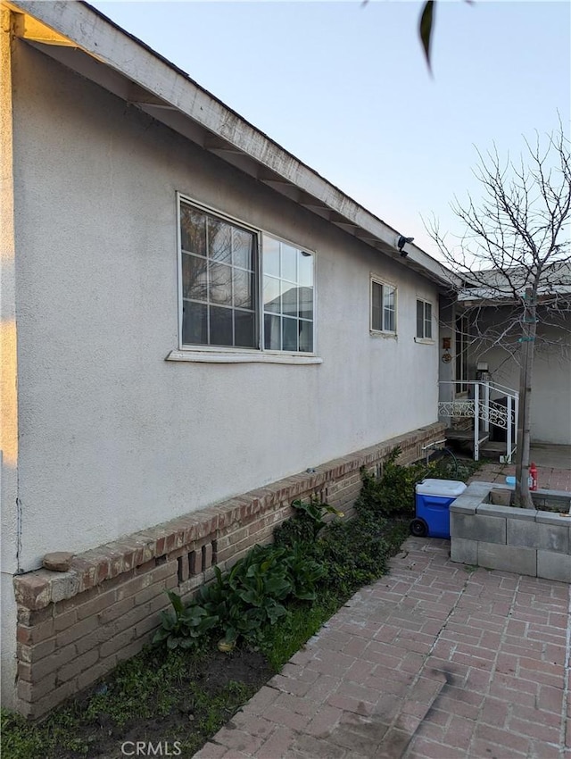 view of side of home featuring a patio area