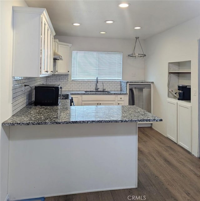 kitchen featuring pendant lighting, sink, dishwasher, light stone counters, and kitchen peninsula