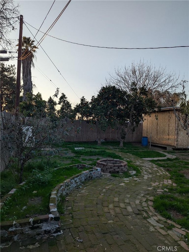 view of yard with an outdoor fire pit