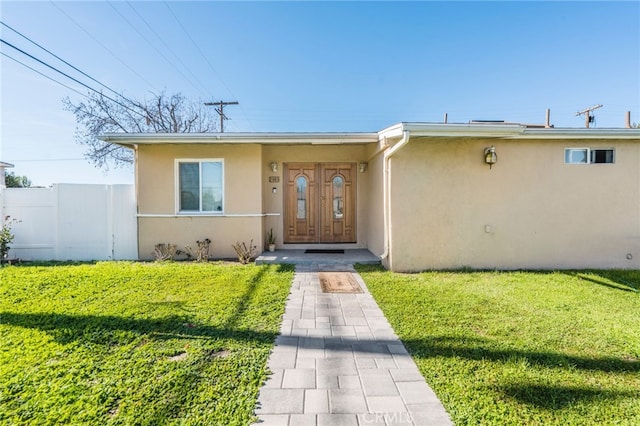 property entrance with a yard