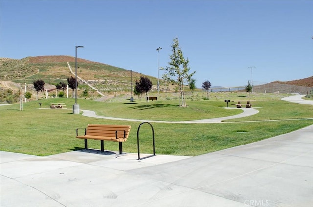 view of home's community with a yard and a mountain view