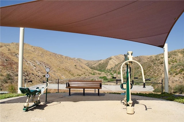 view of community with fence and a mountain view