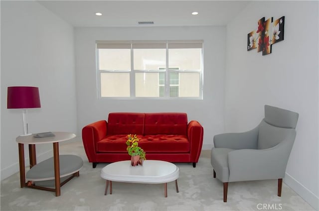 living area featuring recessed lighting, visible vents, and baseboards