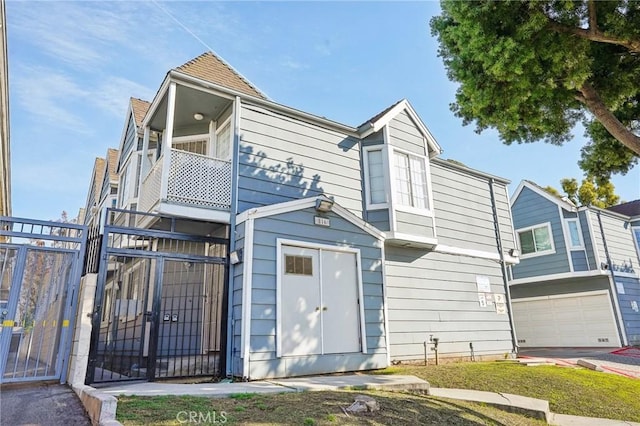 view of front of house with a garage and a balcony