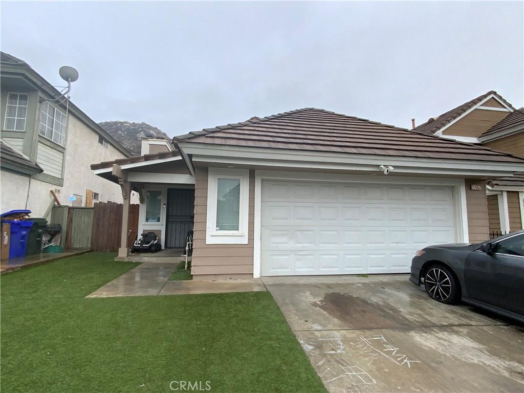 view of front of house with a garage and a front lawn