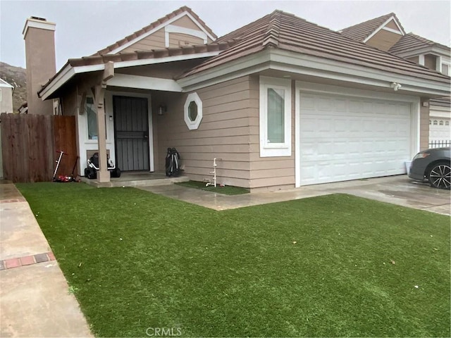 view of front of property with a garage and a front yard