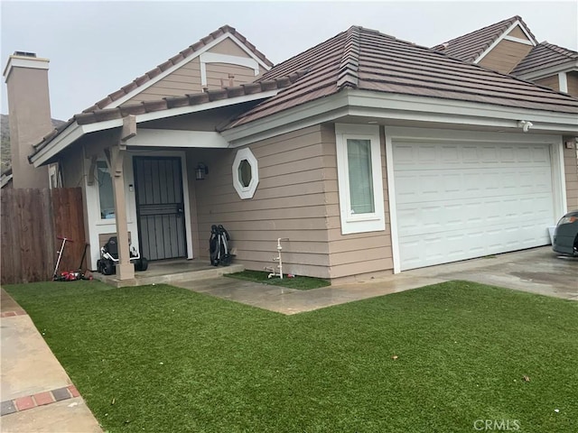 view of front of house with a garage and a front lawn