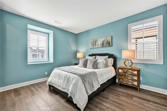 bedroom with dark hardwood / wood-style flooring