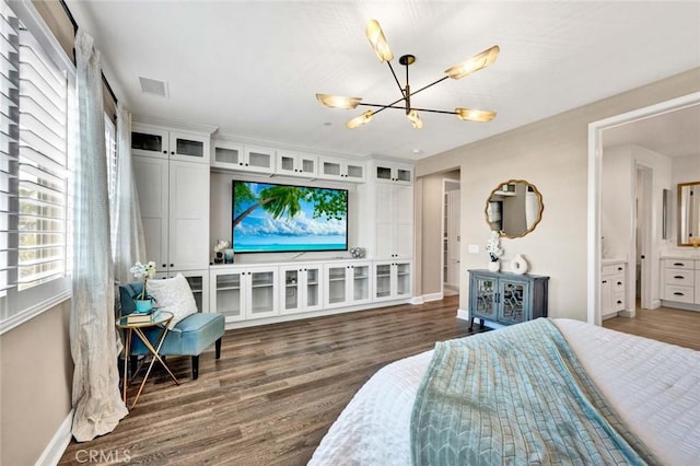 bedroom with dark wood-type flooring and an inviting chandelier