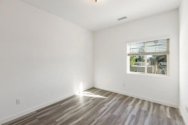 spare room featuring wood-type flooring