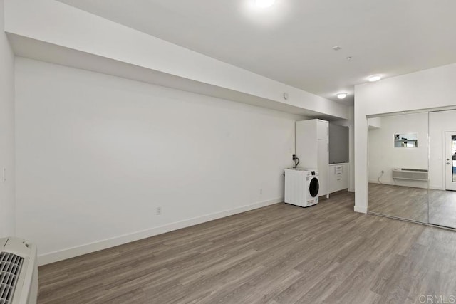 basement with washer / dryer and hardwood / wood-style floors
