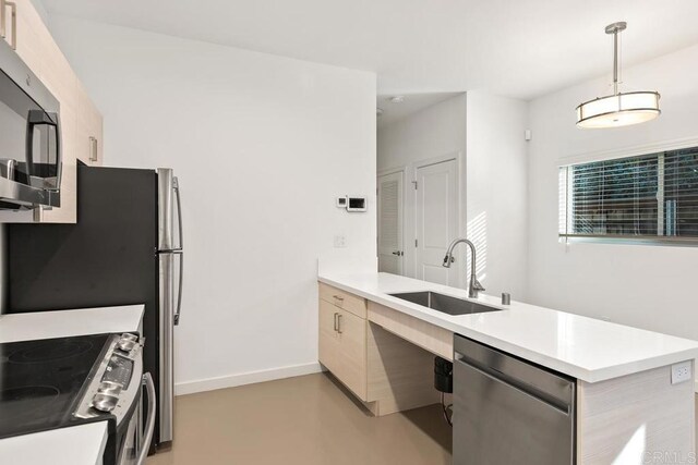 kitchen with pendant lighting, sink, appliances with stainless steel finishes, kitchen peninsula, and light brown cabinets