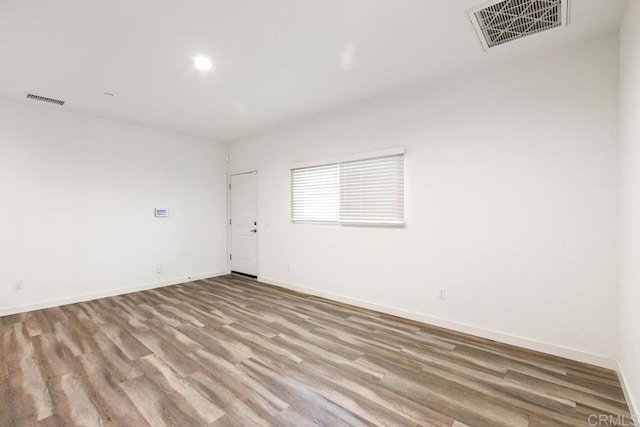empty room with light hardwood / wood-style flooring