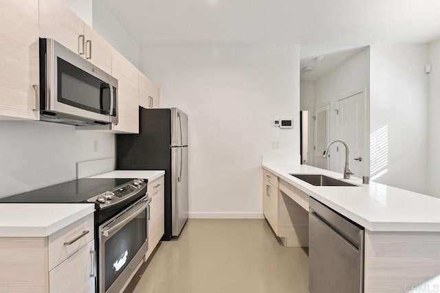 kitchen with stainless steel appliances, kitchen peninsula, and sink
