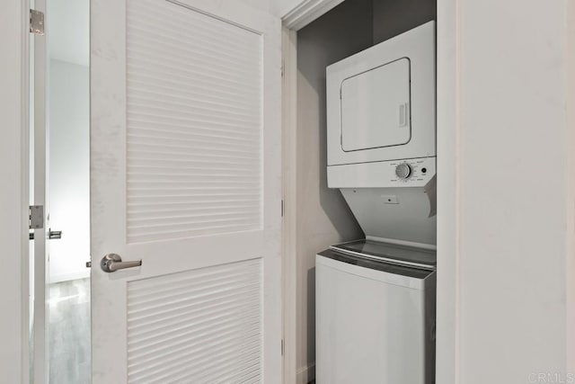 clothes washing area with stacked washer and clothes dryer