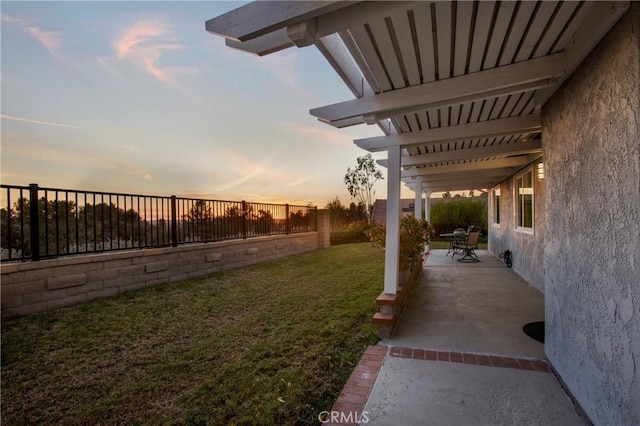 yard at dusk with a patio area