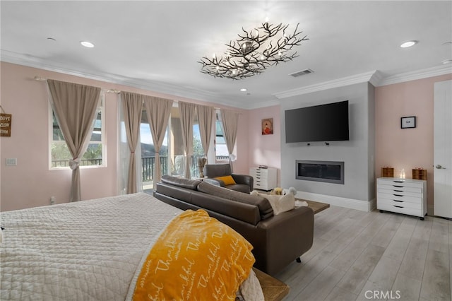 bedroom with multiple windows, crown molding, access to exterior, and light wood-type flooring