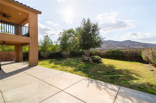 exterior space featuring a patio, a mountain view, and ceiling fan