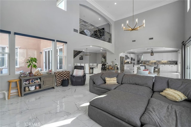 living room with crown molding and a notable chandelier