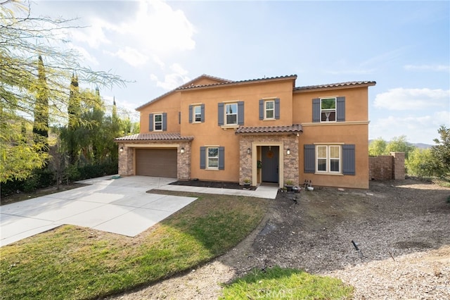 mediterranean / spanish-style home with a garage