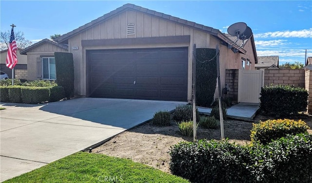 garage featuring concrete driveway