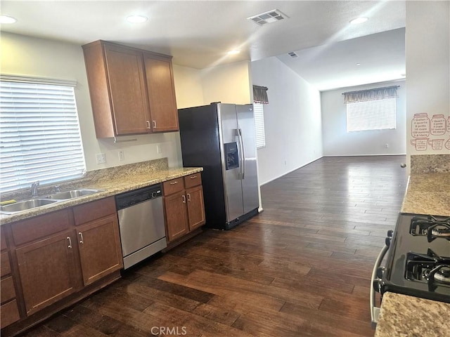 kitchen with visible vents, appliances with stainless steel finishes, dark wood-style flooring, light countertops, and a sink