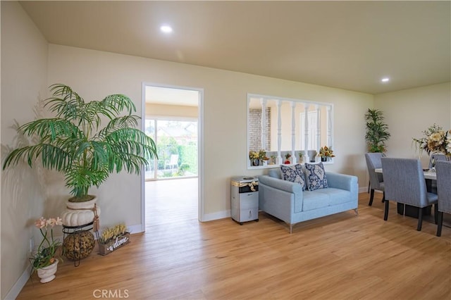 sitting room featuring light wood-style flooring, baseboards, and recessed lighting