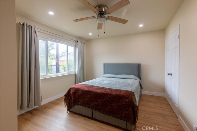 bedroom featuring light hardwood / wood-style flooring and ceiling fan