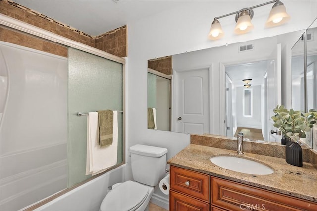 full bath featuring toilet, combined bath / shower with glass door, vanity, and visible vents