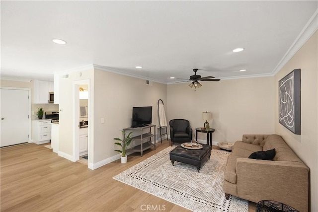 living room with recessed lighting, light wood-style flooring, and crown molding