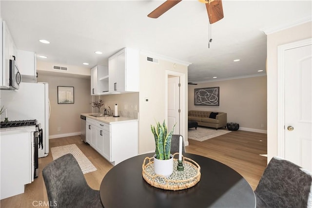 kitchen with stainless steel appliances, open floor plan, visible vents, and a sink